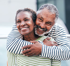 A couple smiling. Links to Beneficiary Designations