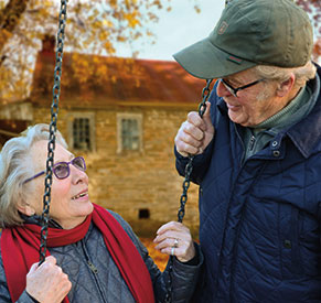 A couple on a swing set. Links to Gifts of Real Estate