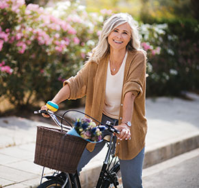 A woman on a bicycle. Links to What to Give