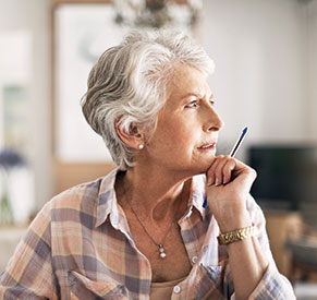 A woman with a pen in her hand. Links to Gifts of Cash, Checks, and Credit Cards